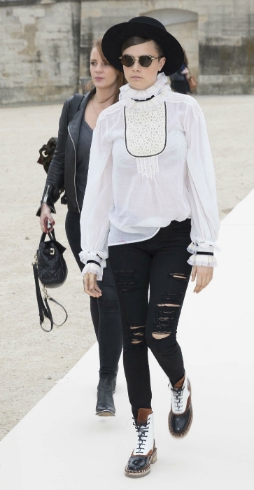 Cara Delevingne white high neck blouse and ripped jeans