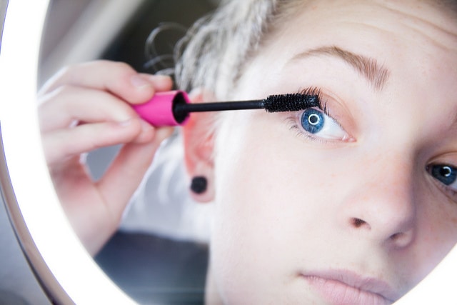 Girl applying mascara