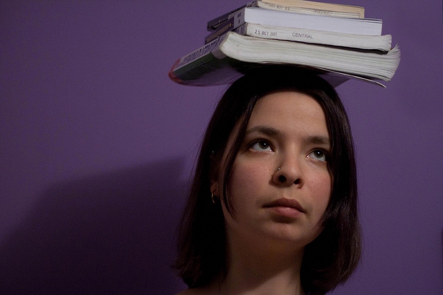 Girl with books on her head