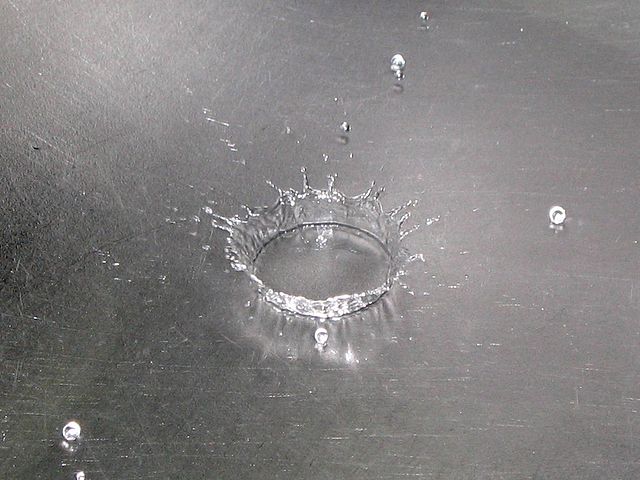 A water droplet splashing onto a surface