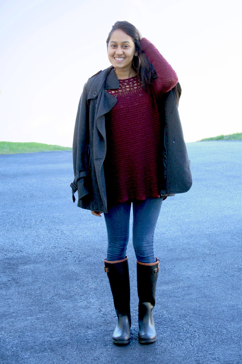 Fall fashion on campus at Assumption College: Red sweater, gray pea coat, skinny jeans, knee high boots