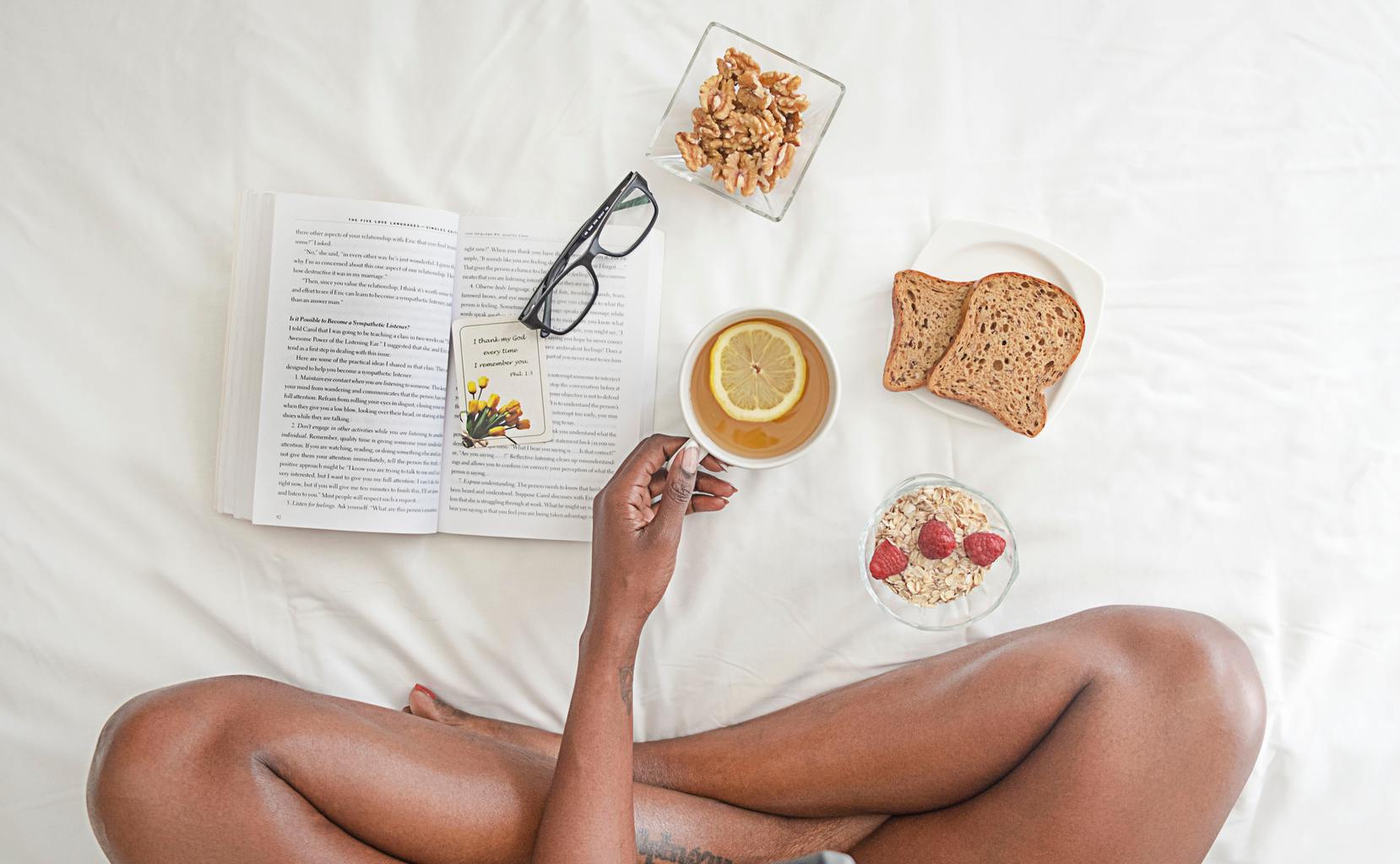 person-bed-book-food-glasses