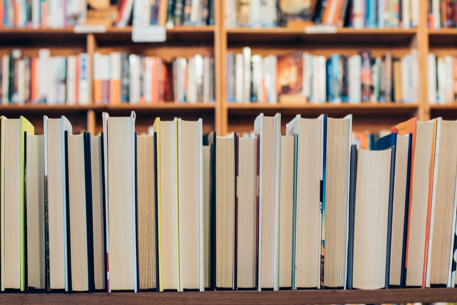 A shelf of books with the spines facing away from the camera