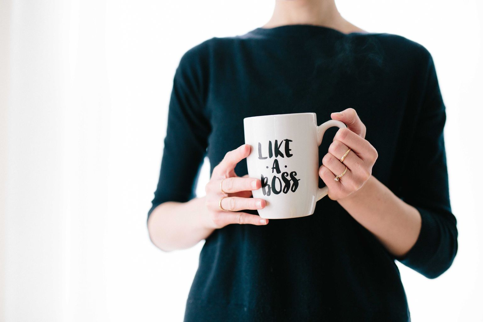 Interview Hair, Nails, and Perfume tips: Woman holding a mug that says Like a Boss