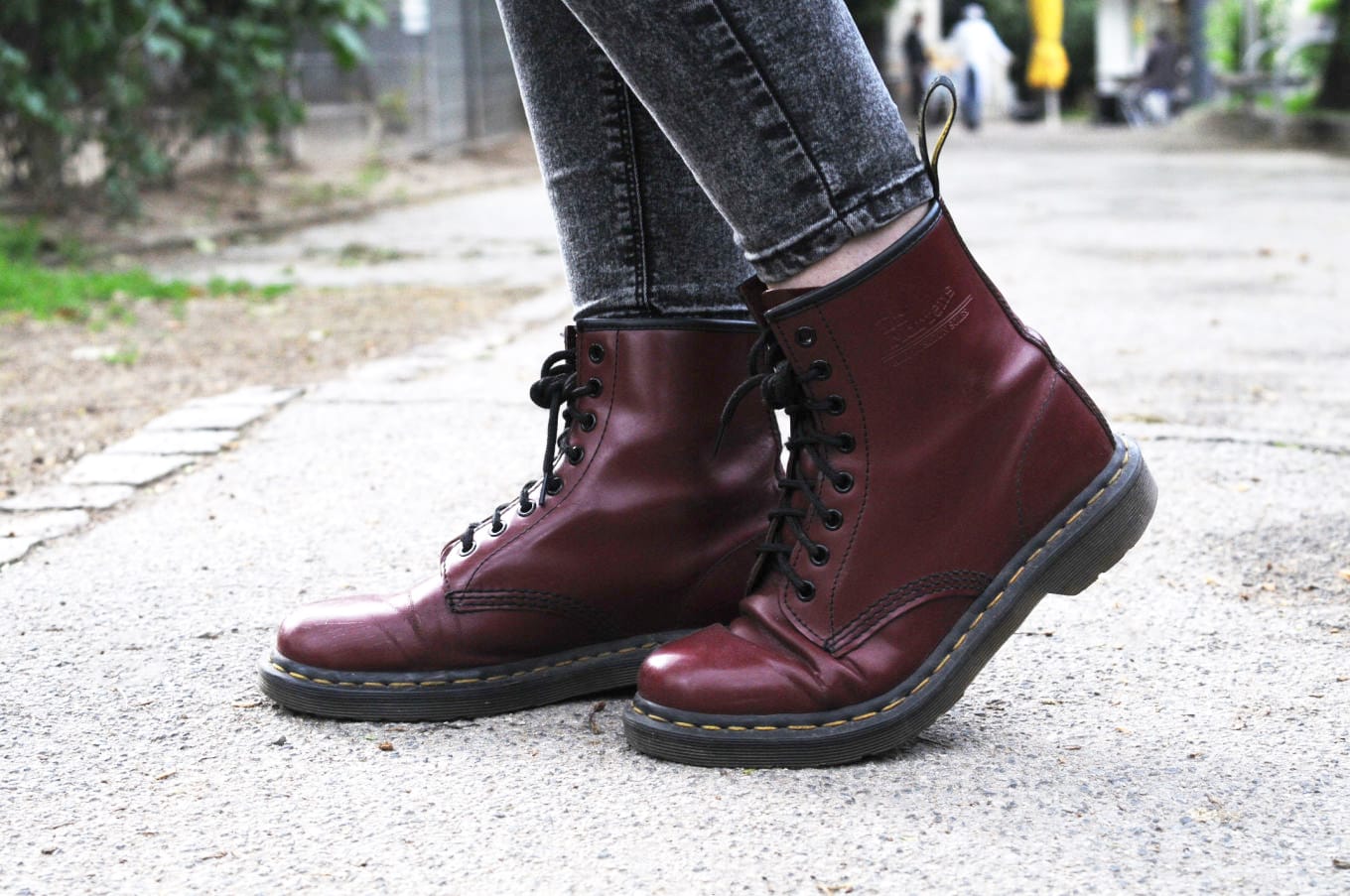 Maroon Doc Martens boots with black laces on campus