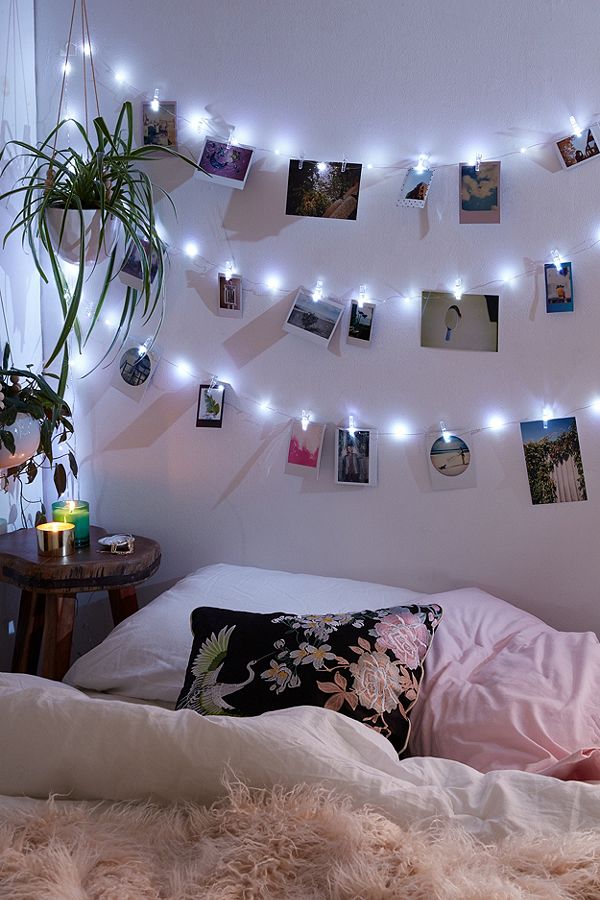 Chhristmas lights as a headboard with photos clipped on