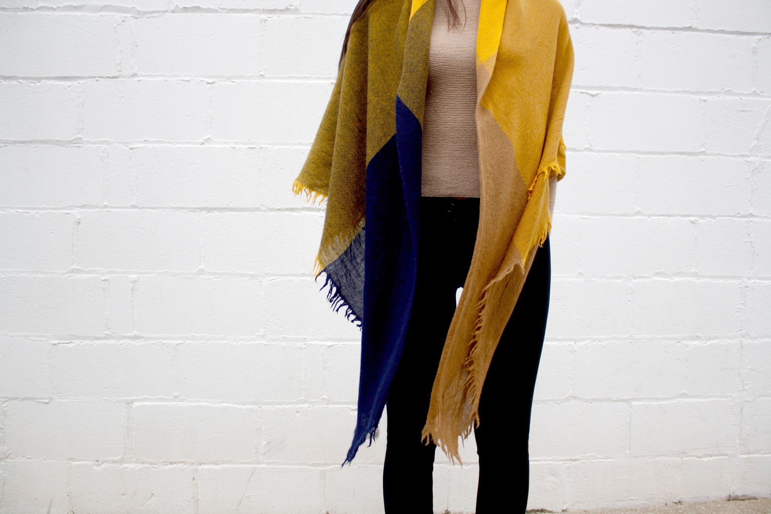 A college student at Western University wears a yellow and blue scarf as a shawl with leggings