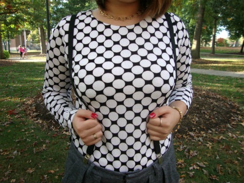 College student wearing a polka dot sweater and suspenders