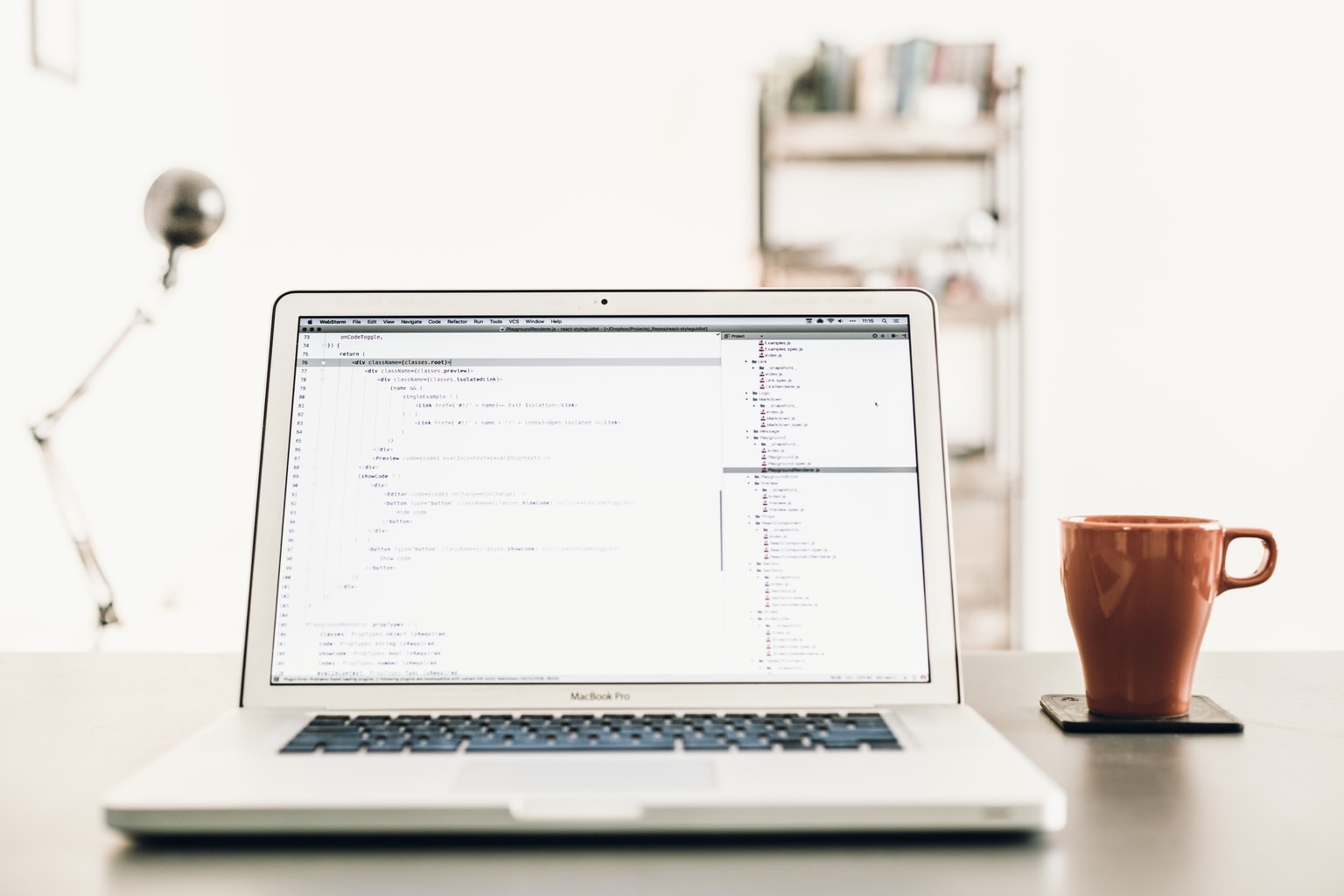 Computer next to a cup of coffee