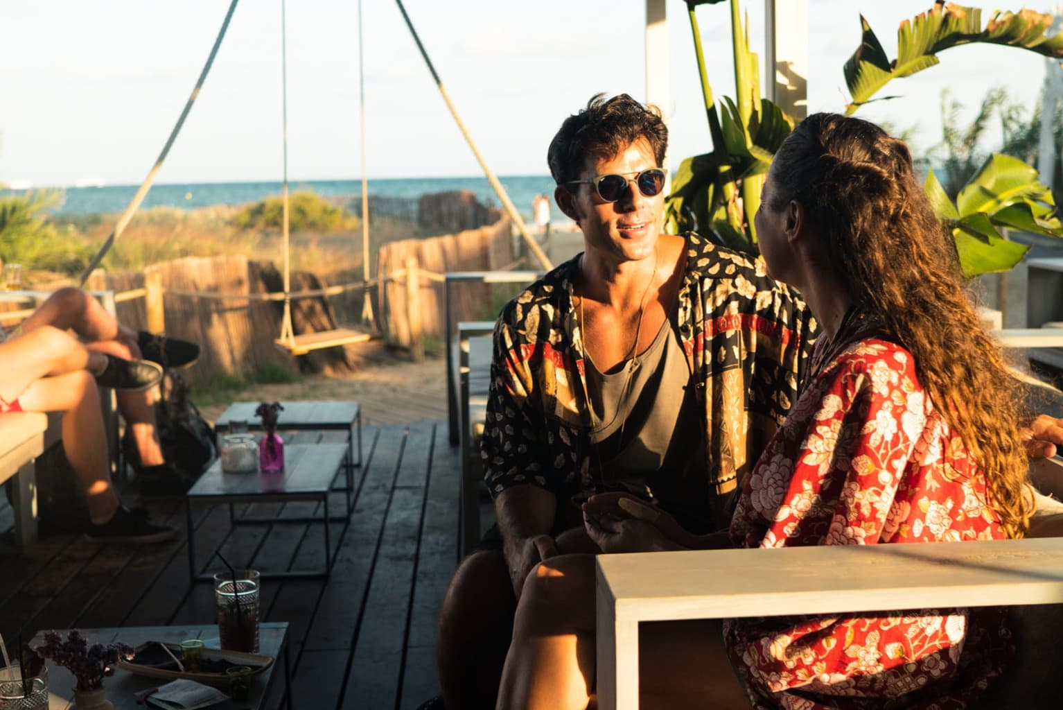 Man and woman at the beach sitting at a table