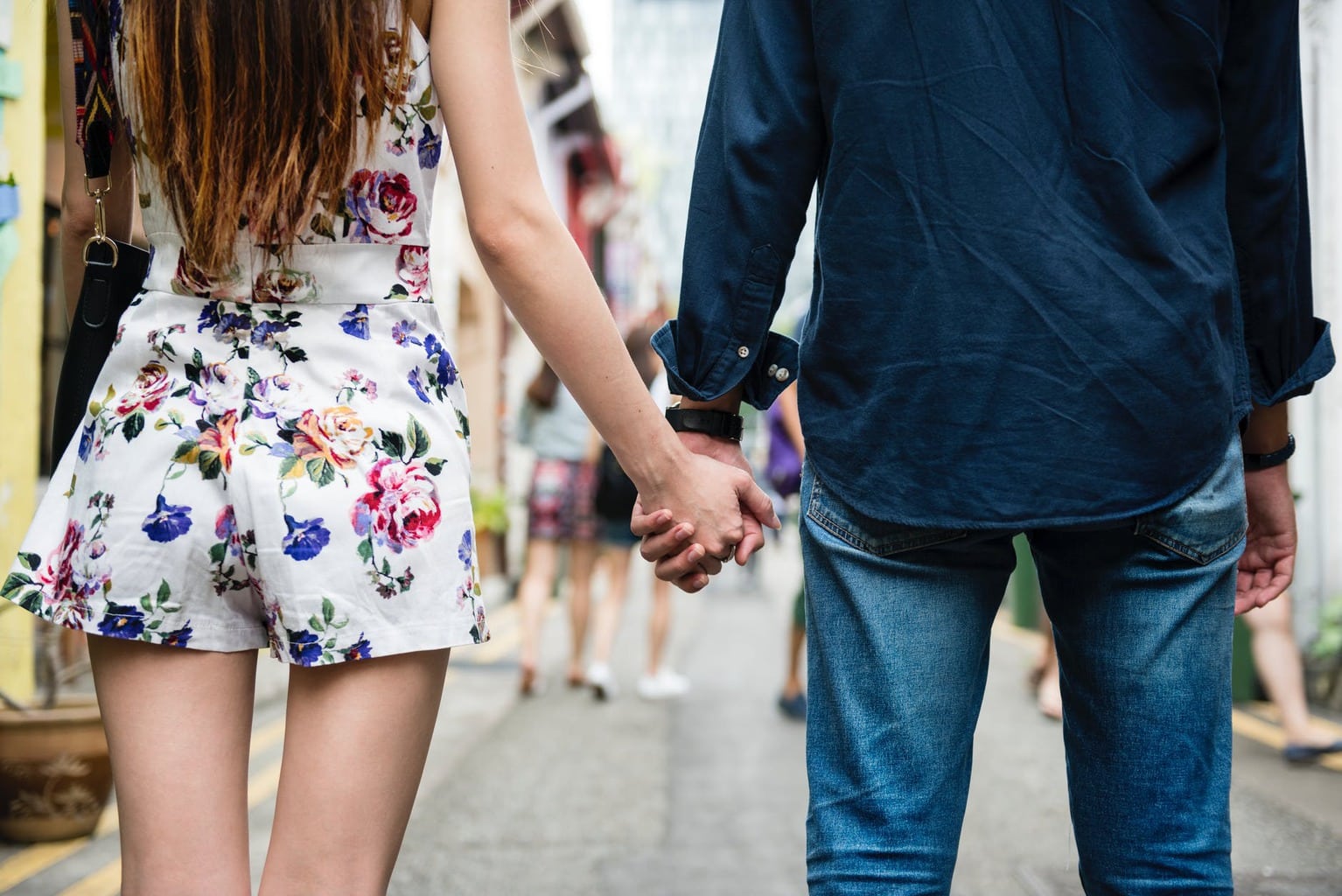 Couple walking down the street and holding hands