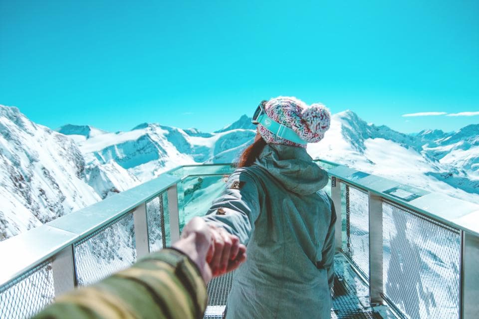 Girl holding hands with someone on a mountain