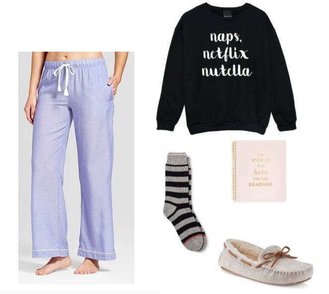 Study outfit for a night in: Purple pajama pants, a sweatshirt that reads Naps, Netflix, Nutella, cozy socks, slippers, and a Kate Spade notebook that reads The World Was Hers for the Reading