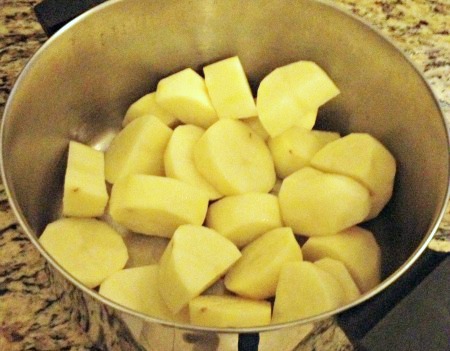 Cut potatoes in pot