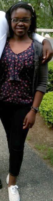 Young girl wearing a floral top and headband
