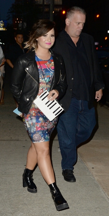 Demi Lovato wearing a printed dress and moto jacket