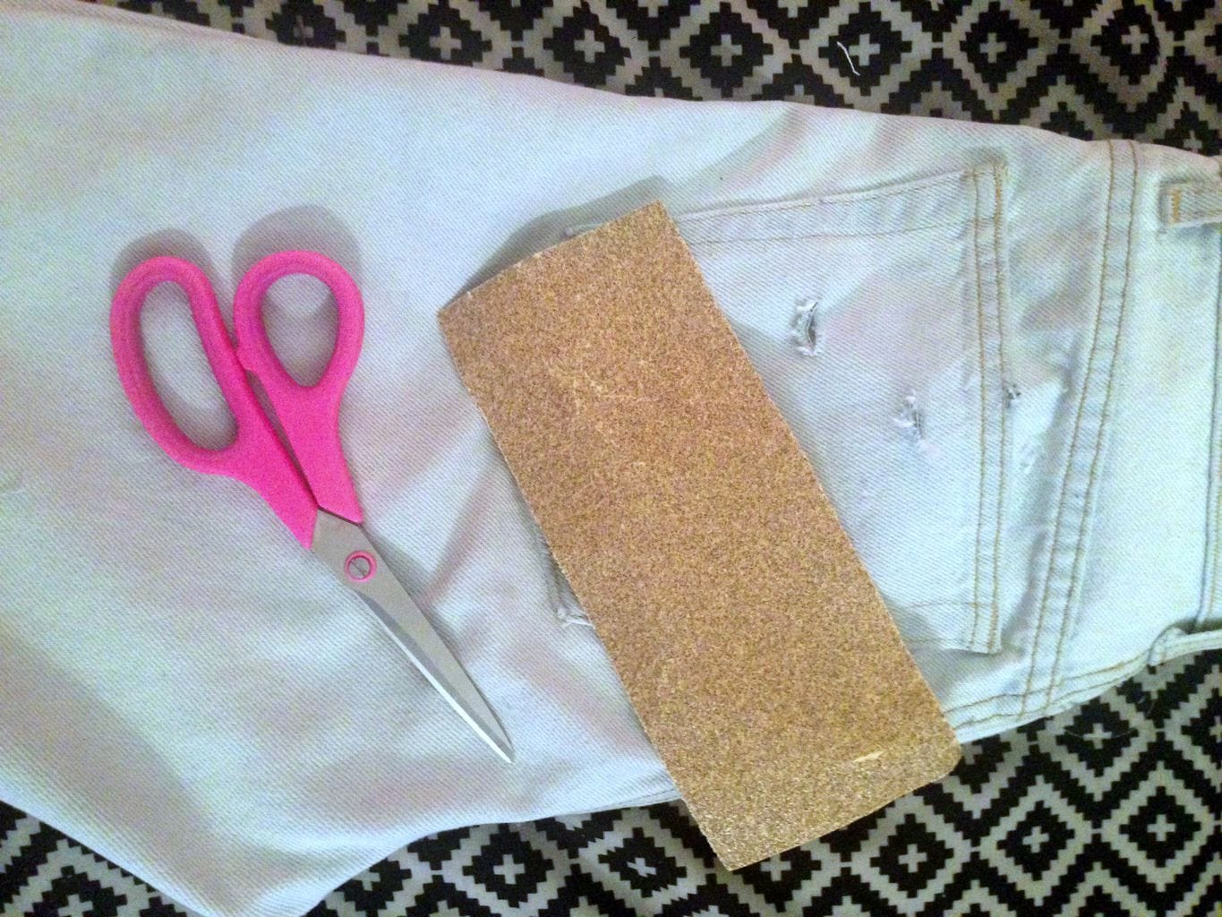 DIY distressed jeans sandpaper