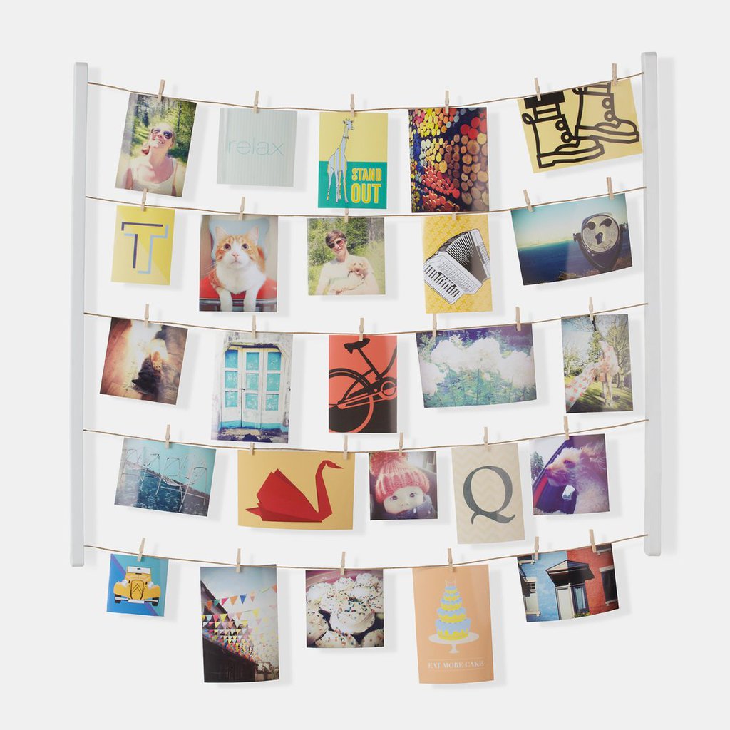 Dormify hanging photo display with wooden clips.