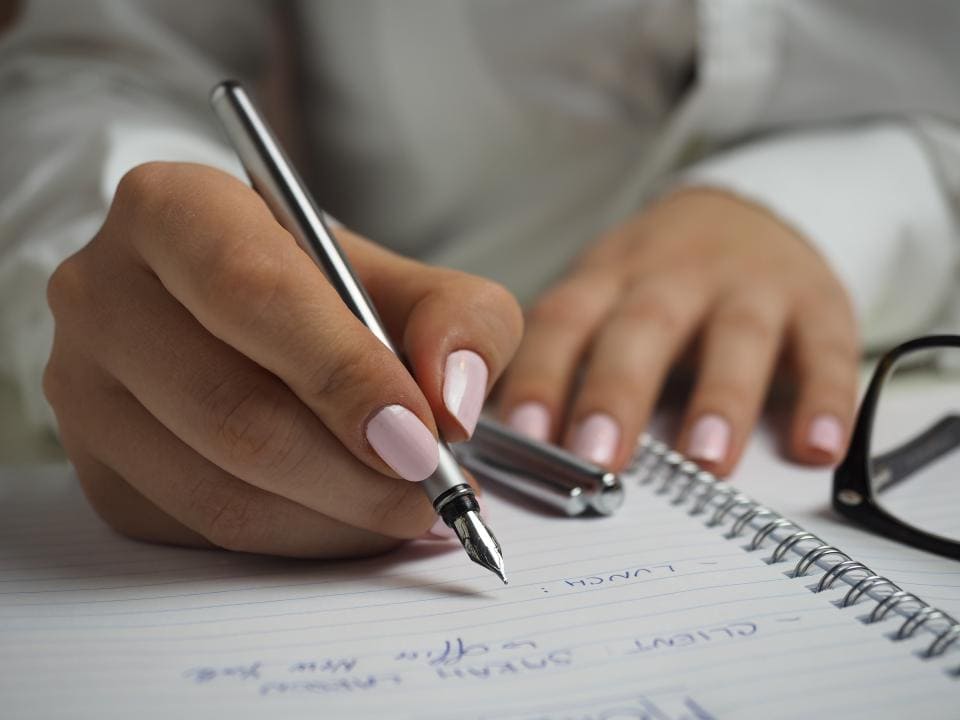 up close photo of hands writing