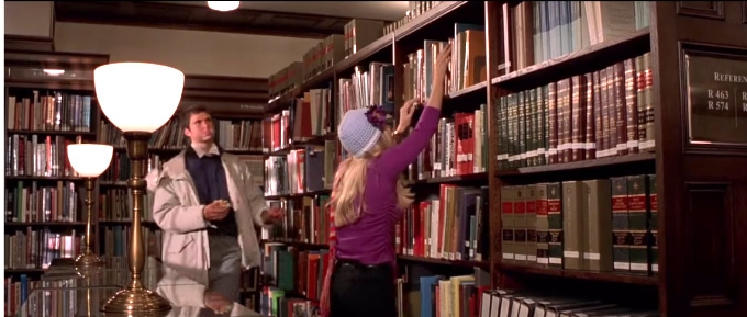 Elle Woods trying to get a book down from the shelf in the library - screenshot from the movie Legally Blonde