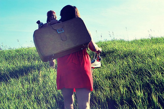 Girl carrying a suitcase