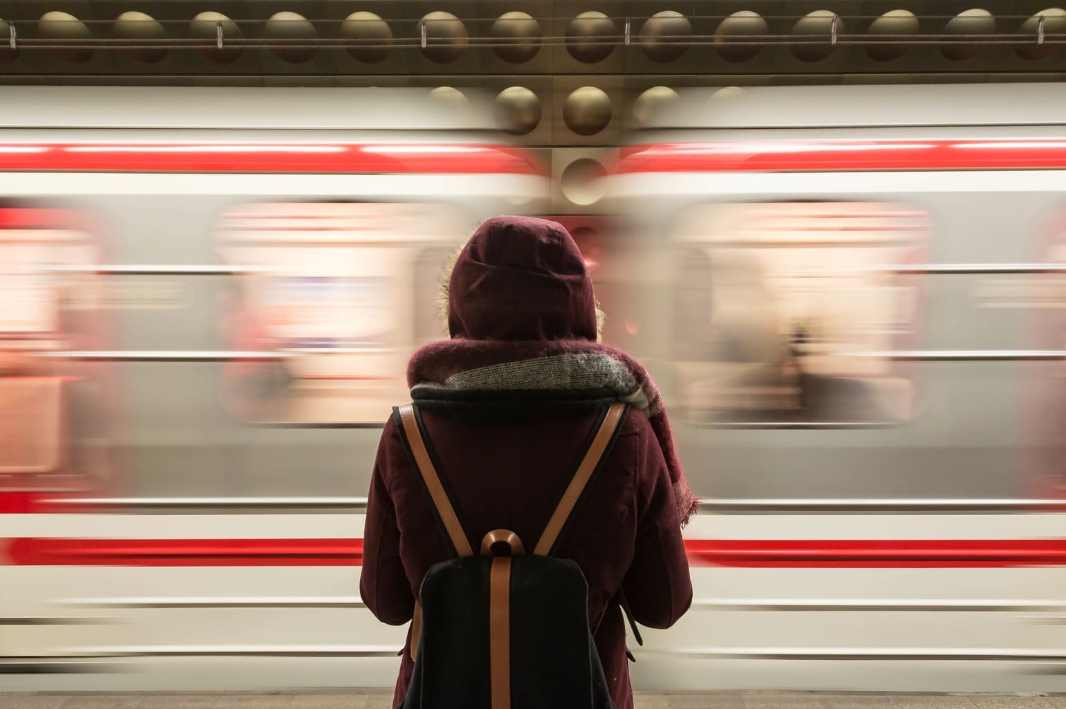 Girl standing in front of a train.