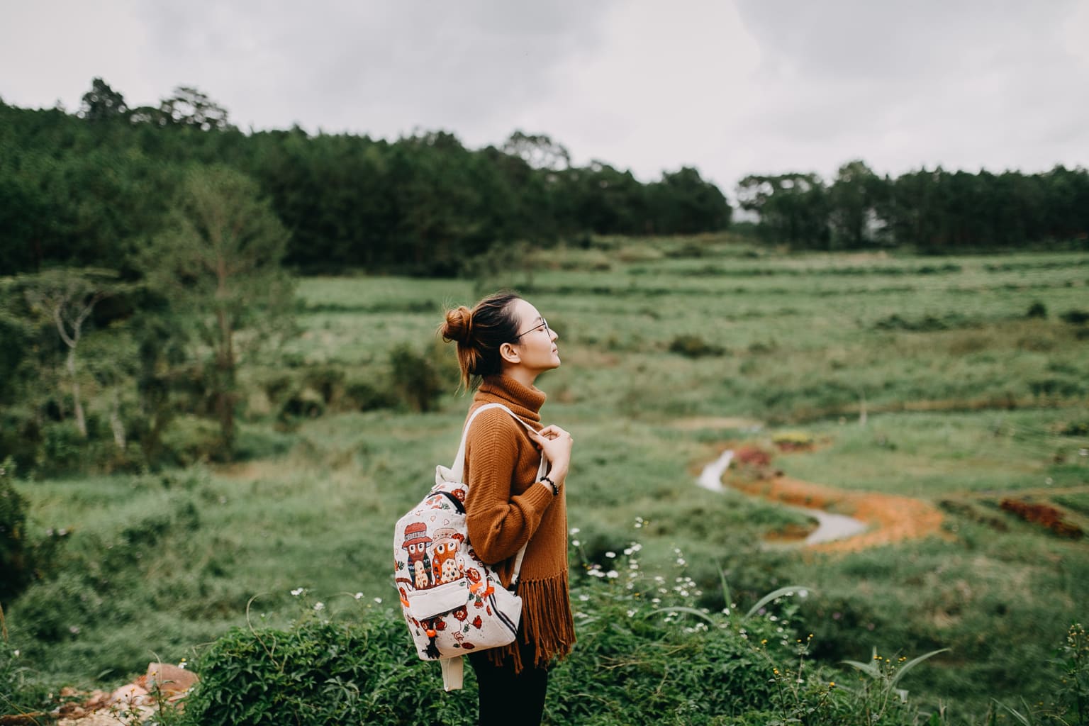 girl in nature with backpack