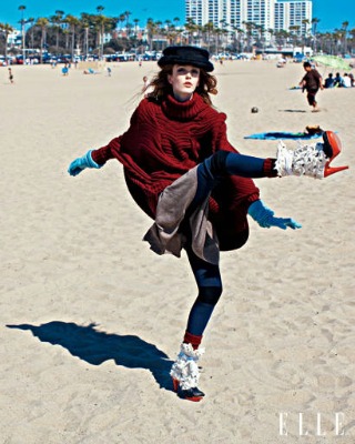 Girl in winter clothes on a beach