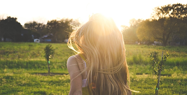 Girl running through field