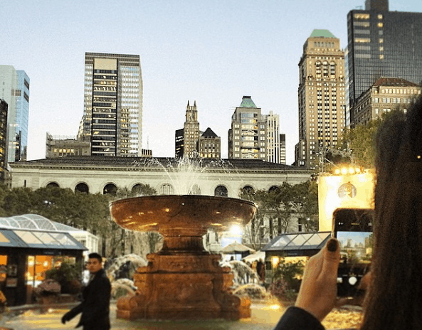 girl taking picture of skyline - instagram profiles worth following
