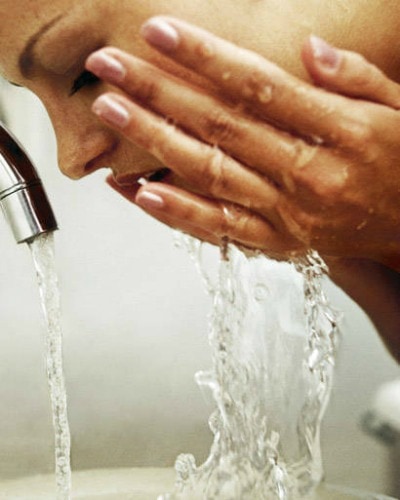 Girl washing her face