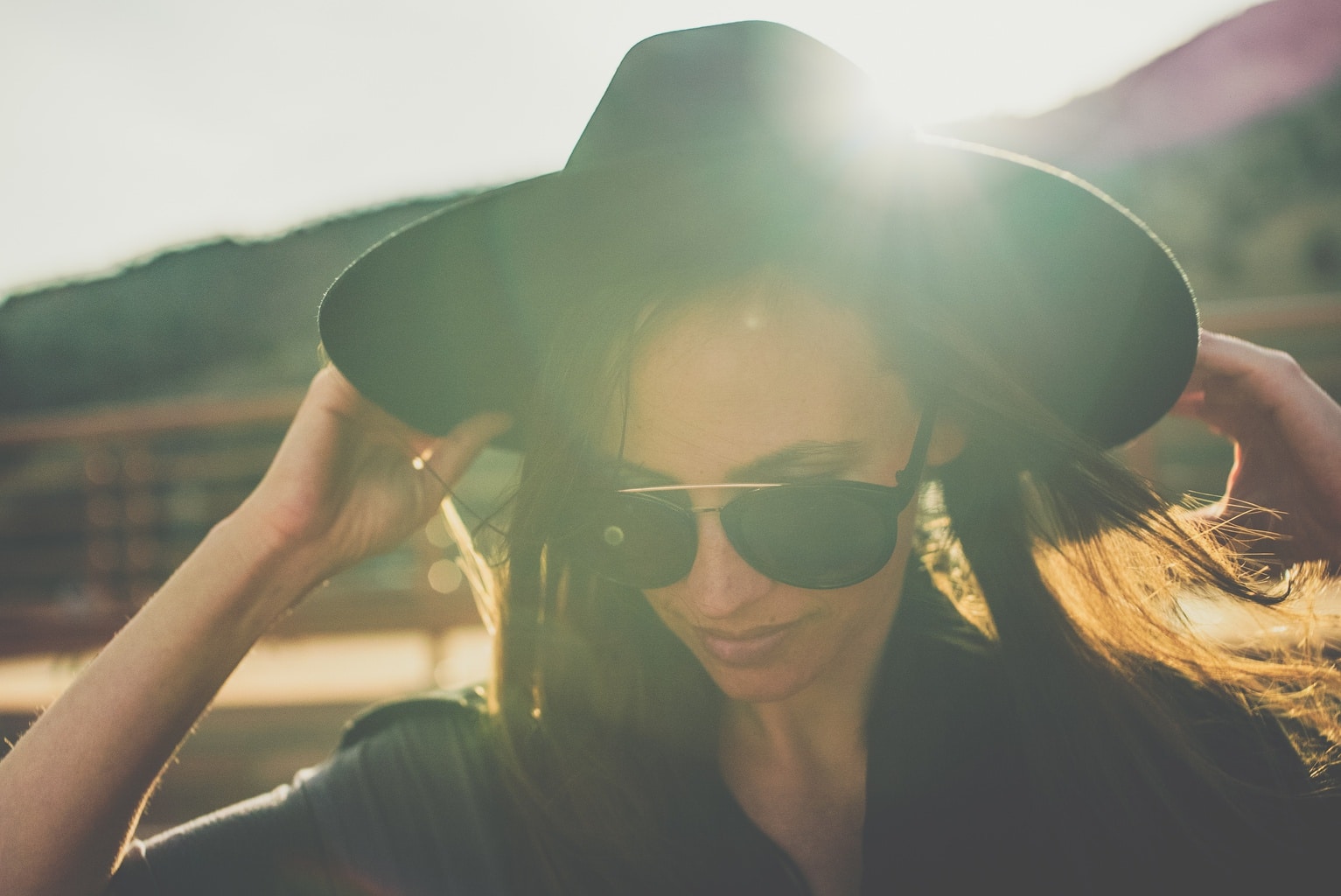 Girl wearing a big hat early in the morning