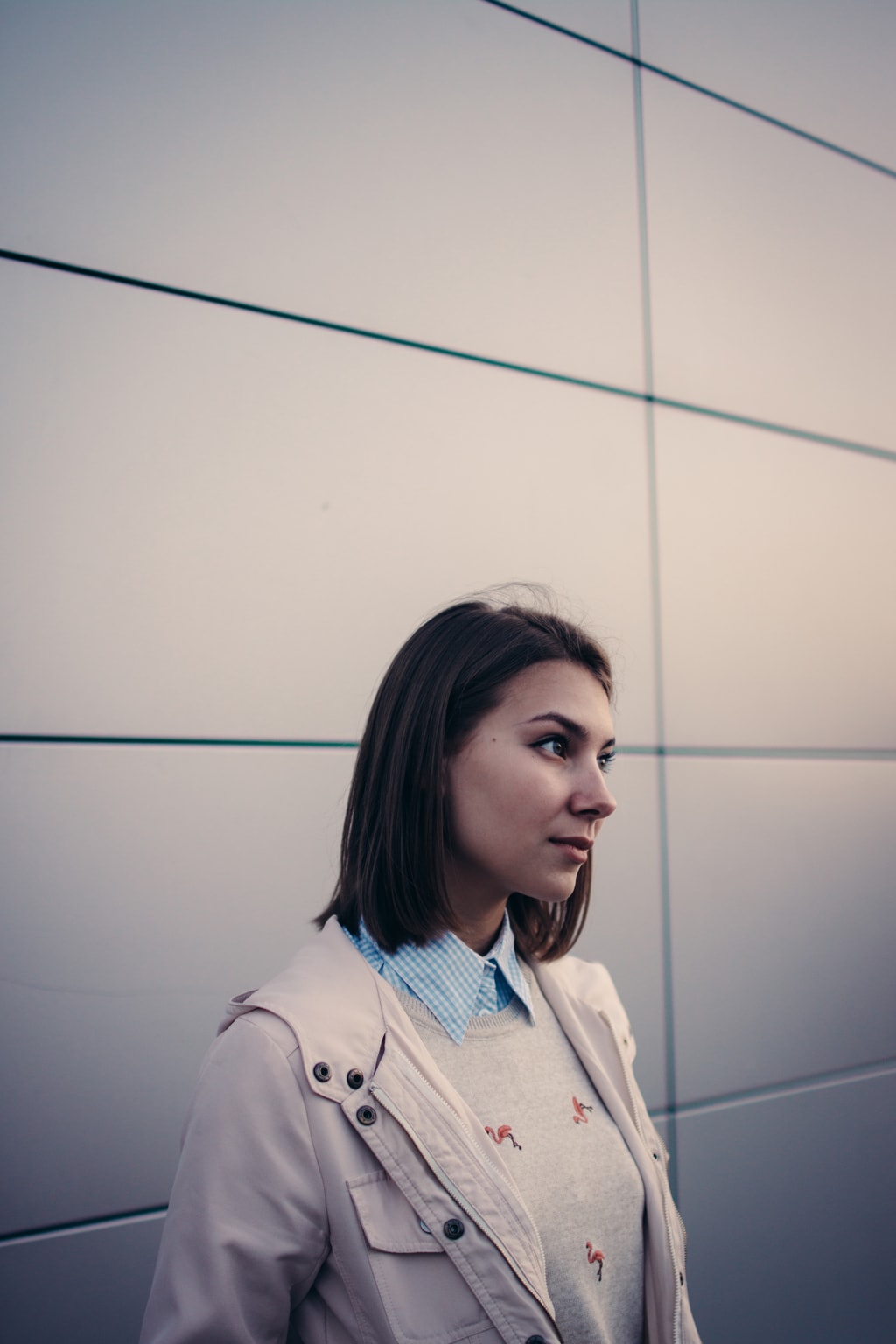 Girl wearing a jacket over a sweater and button-up shirt