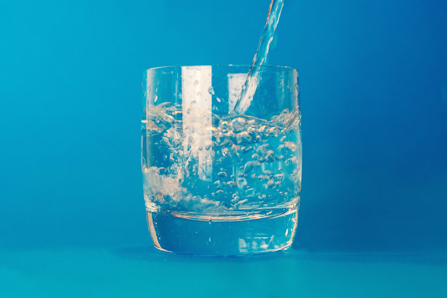 glass of water with blue background