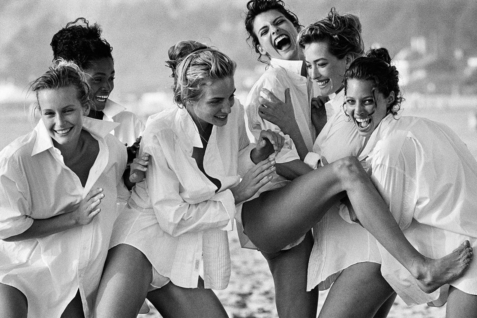 Group of girls laughing in white button-downs.