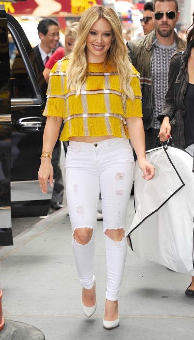 Hilary Duff in a yellow top and white jeans