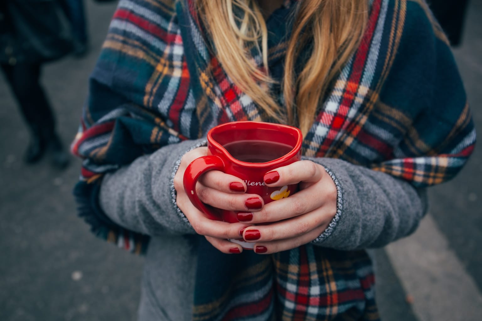 Girl holding a red mug of coffee