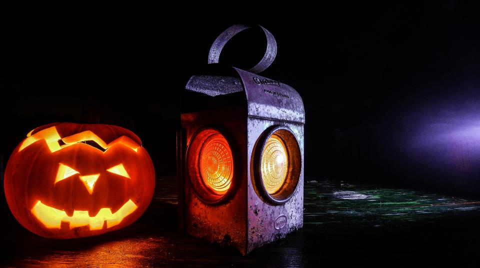 Jack-o-lantern and real latern in the dark