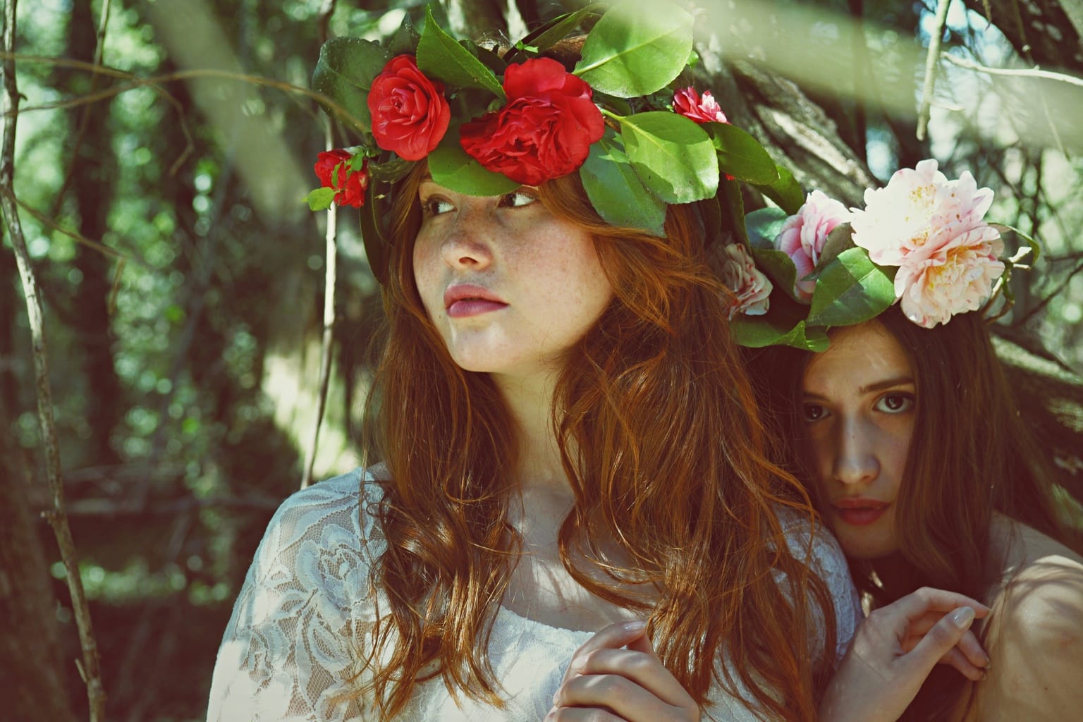 Two women wearing flower crowns