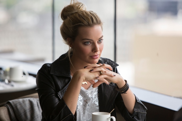 Margot Robbie in Focus wearing a leather jacket