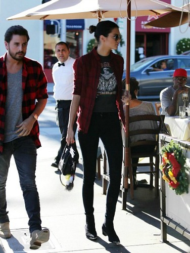 Kendall Jenner wearing a band tee and flannel shirt