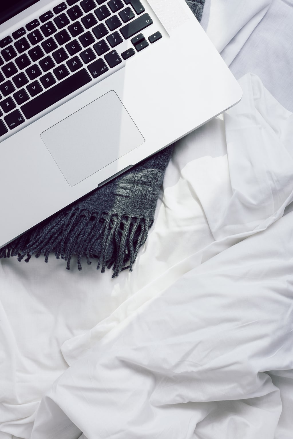 Laptop on a bed - self care lessons from chronic illness