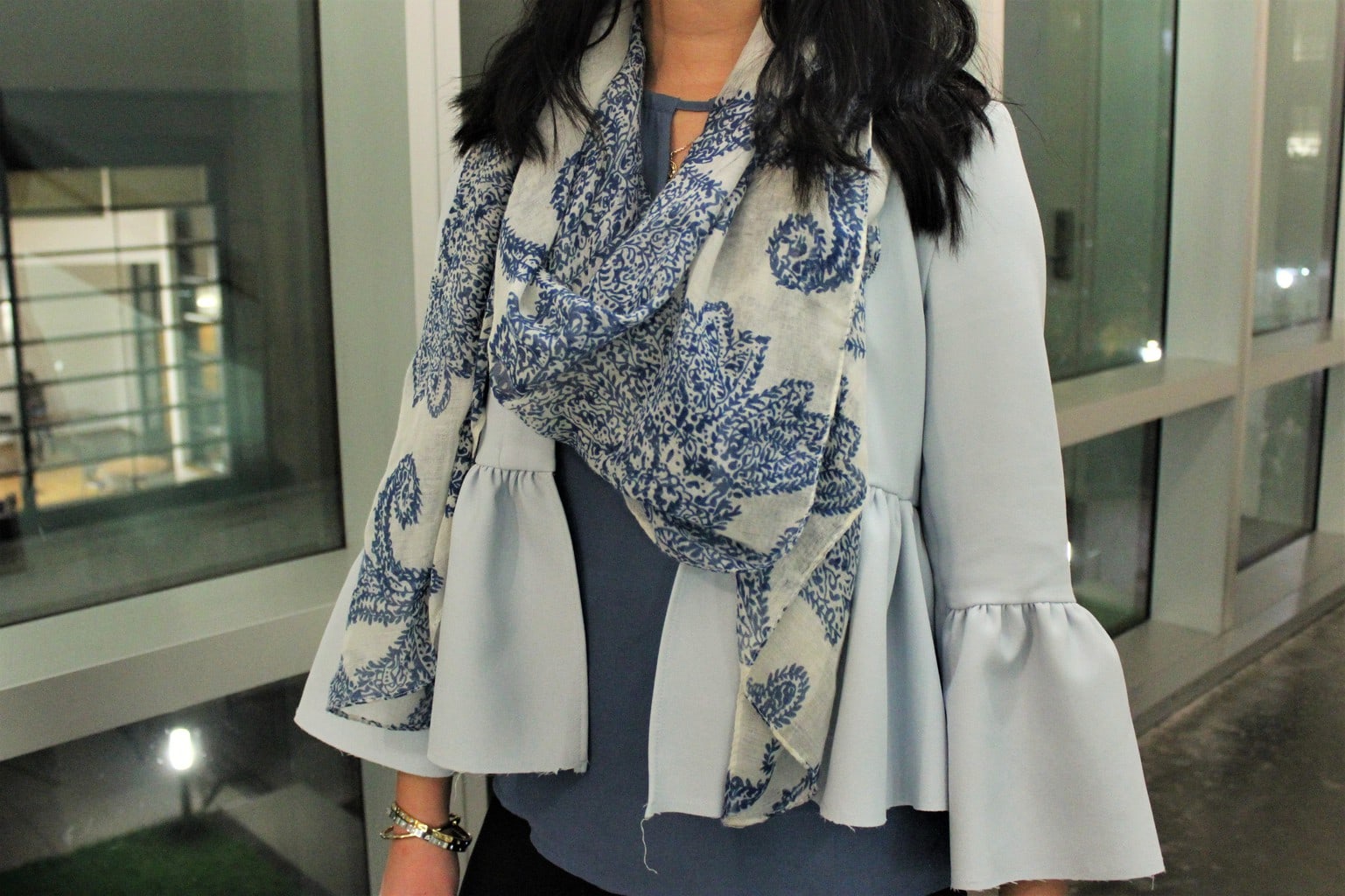 Catherine's baby blue peplum jacket also has bell sleeves, which she pairs with a blue and white paisley scarf.