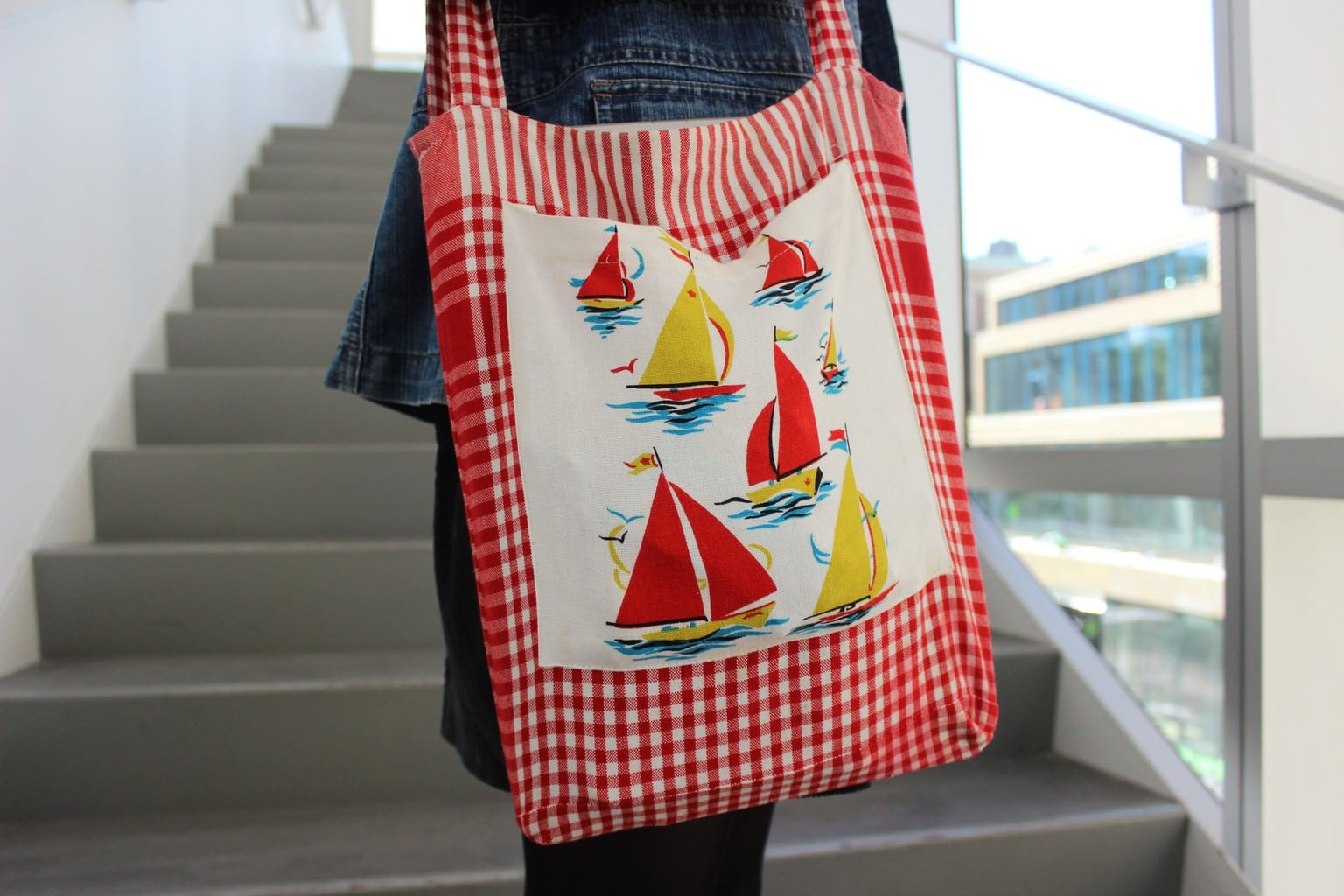 This red and white gingham totebag has a sailboat pattern.