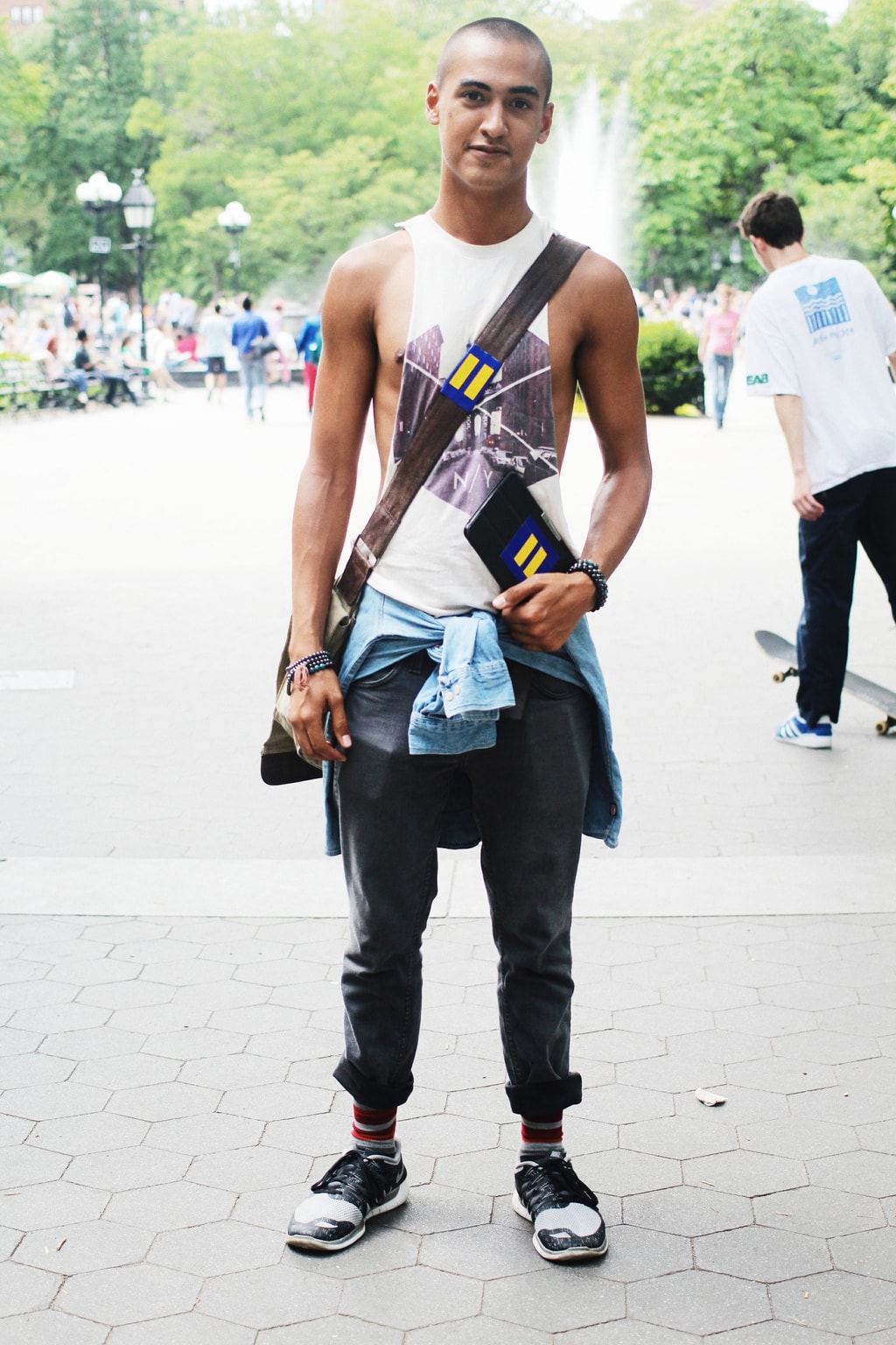 Men's street fashion in NYC: Student Kamron rocks layers, a muscle tank, striped socks, and sneakers