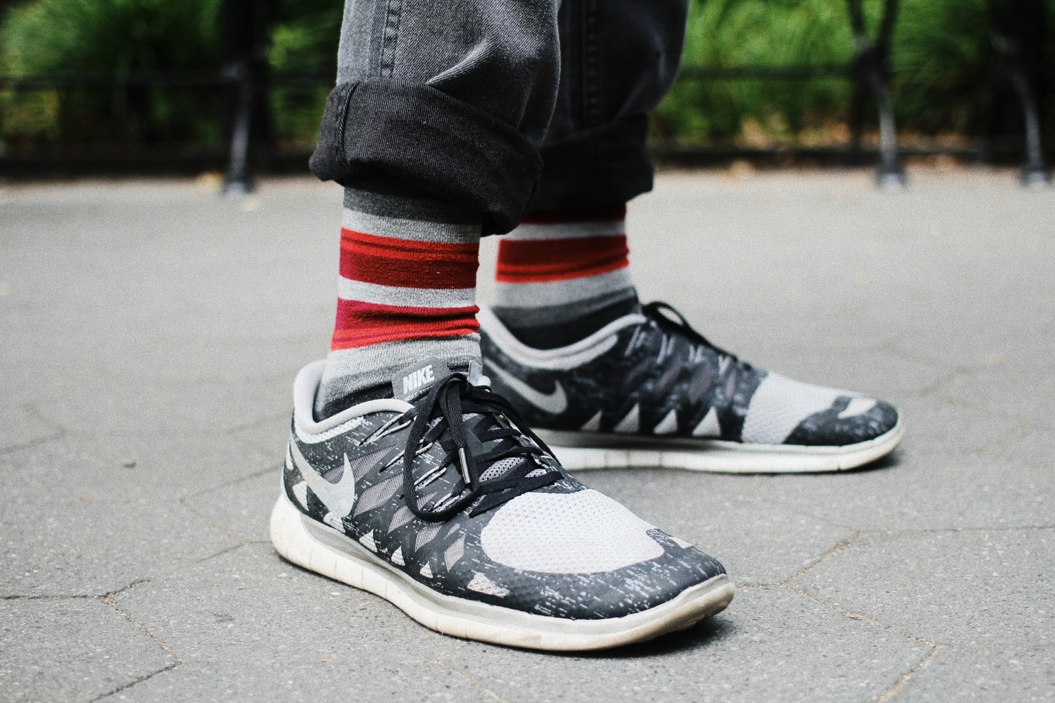 Guy's fashion in college: Nike sneakers and red and white striped socks