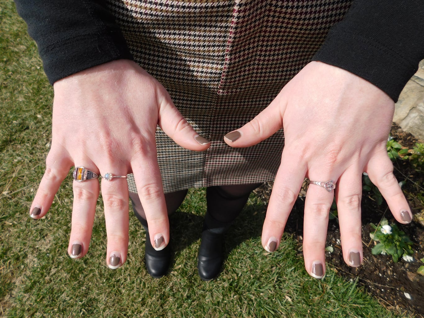 Hannah wears an orange high school class ring, and two simple silver rings from her study abroad programs in Rome and Dublin.