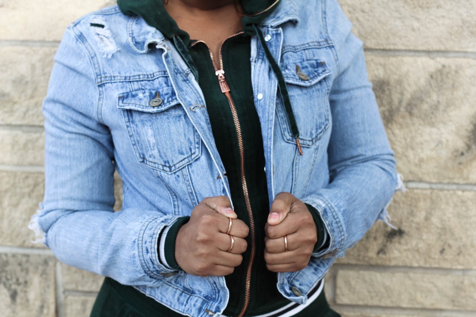 Chaunice's emerald velour tracksuit hoodie with a rosegold zipper is grungier with her light denim jacket over the top.