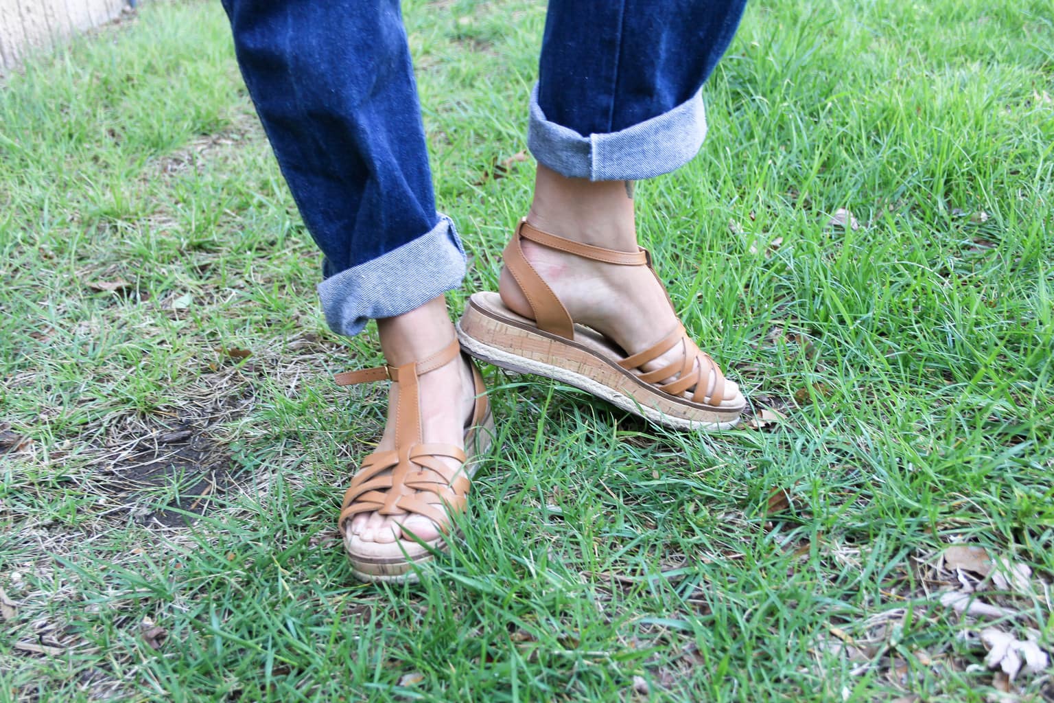 These brown woven sandals have a small cork platform and an ankle strap to keep them in place.