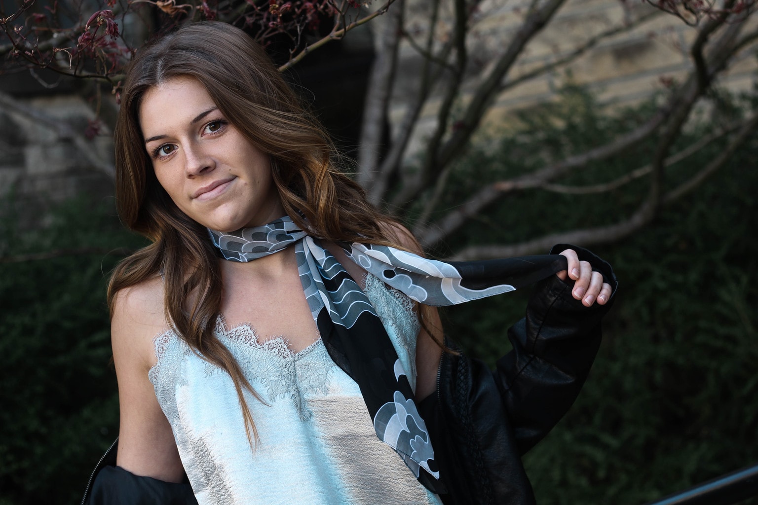 Maddie rocks a grey and black silky ascot scarf with her silk silver lace camisole.